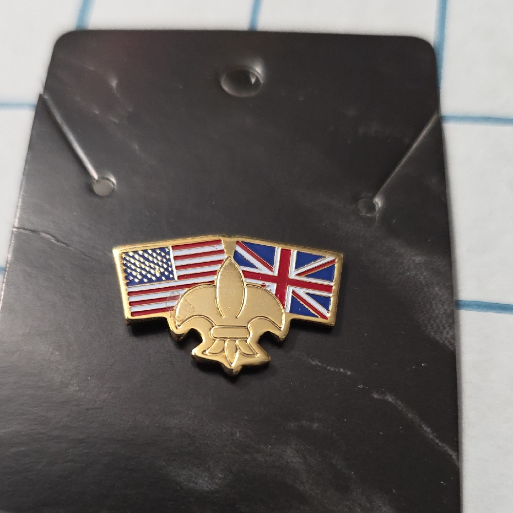 Boy Scouts of America (BSA) Pin Set Against American and British Flags
